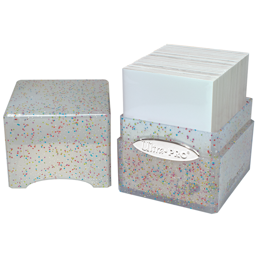 Ultra PRO glitter deck box holding sleeved trading cards. Clear plastic container with multicolored confetti and silver logo