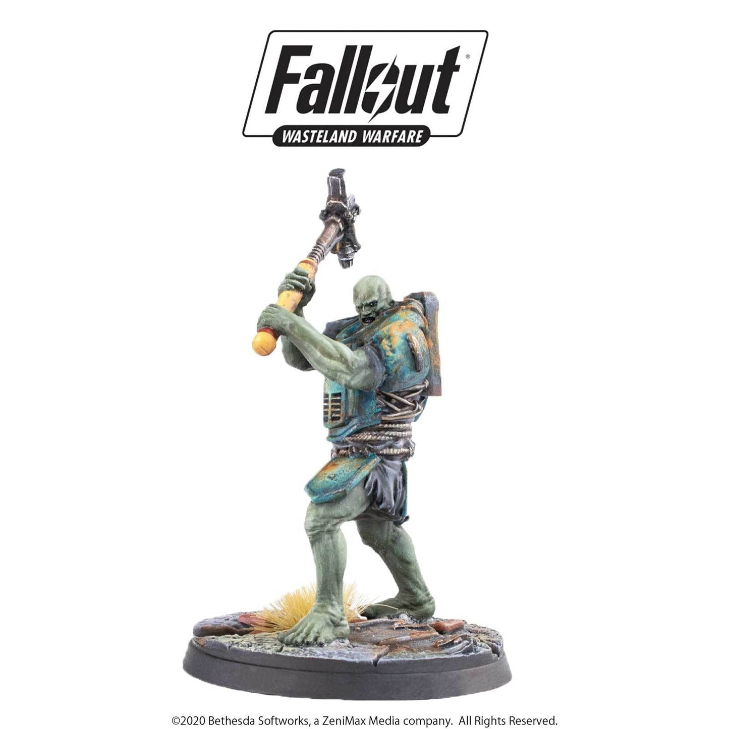 A green-skinned Fallout Ghoul miniature, in tattered clothes, raises a large crude hammer overhead ready to strike