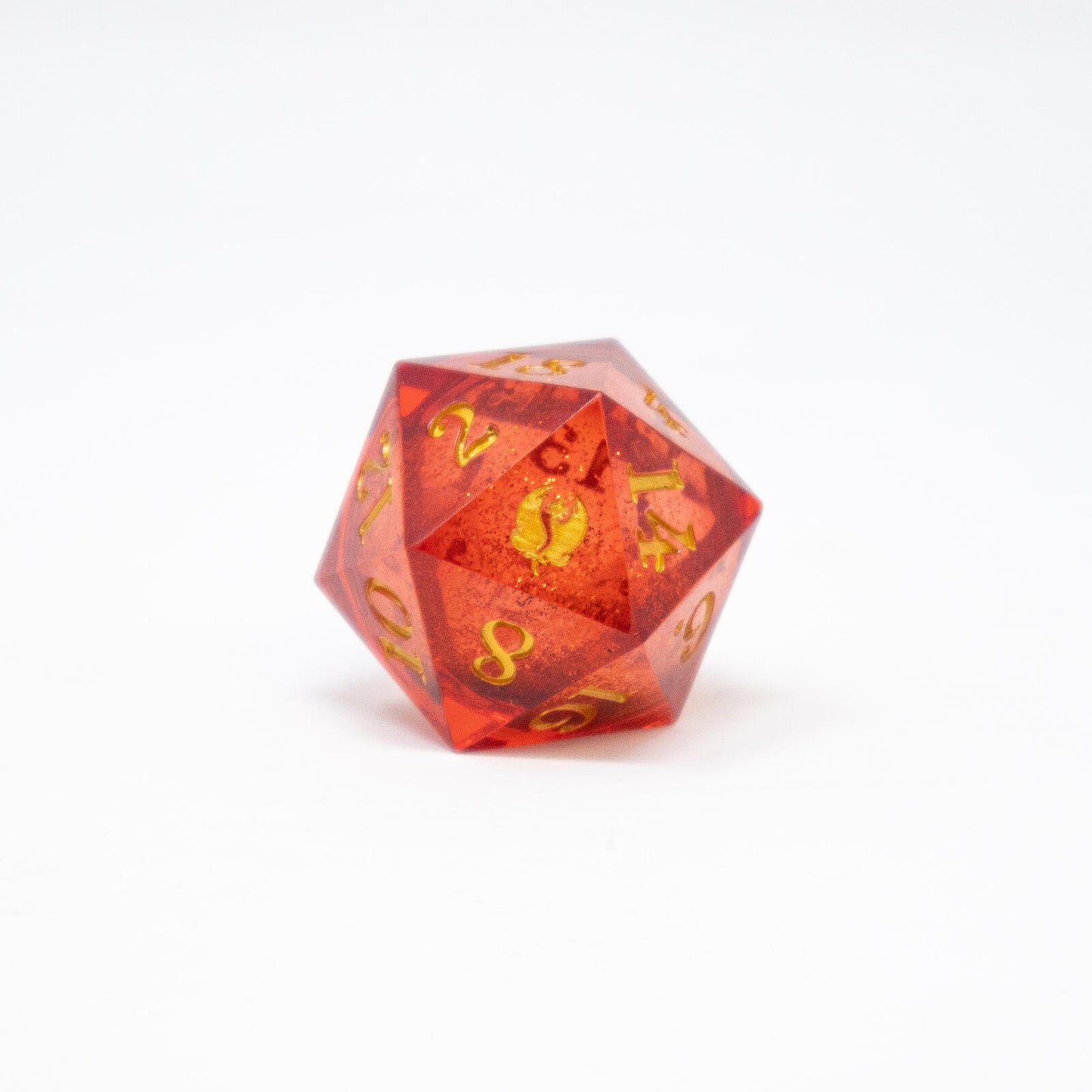 A bloom pink liquid core D20 dice with gold numbers sits on a white background