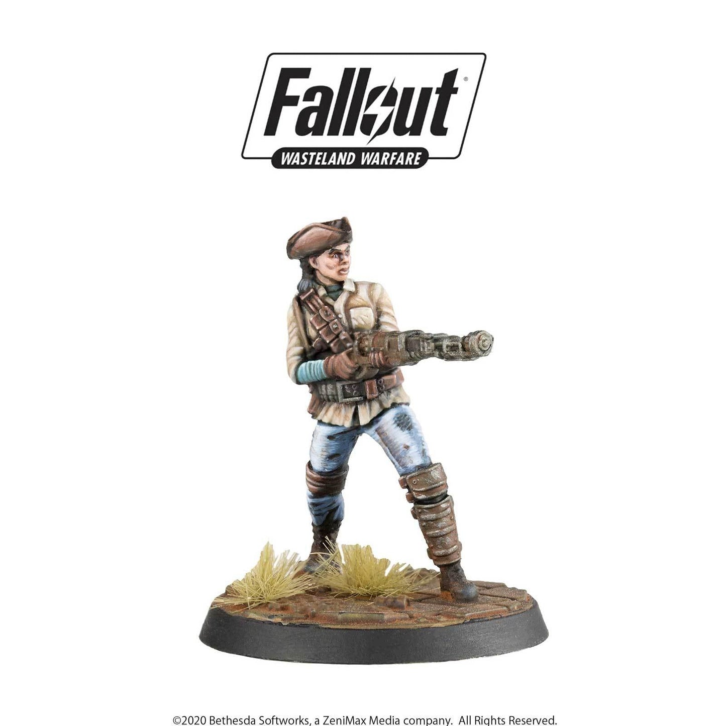 A painted Fallout Wasteland Warfare female miniature in a hat and jacket aims a Gatling gun forward.