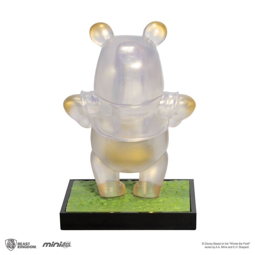 Iridescent clear Mini Egg Attack MEA-013 Winnie the Pooh figure with gold ear and paw details on a green and black base
