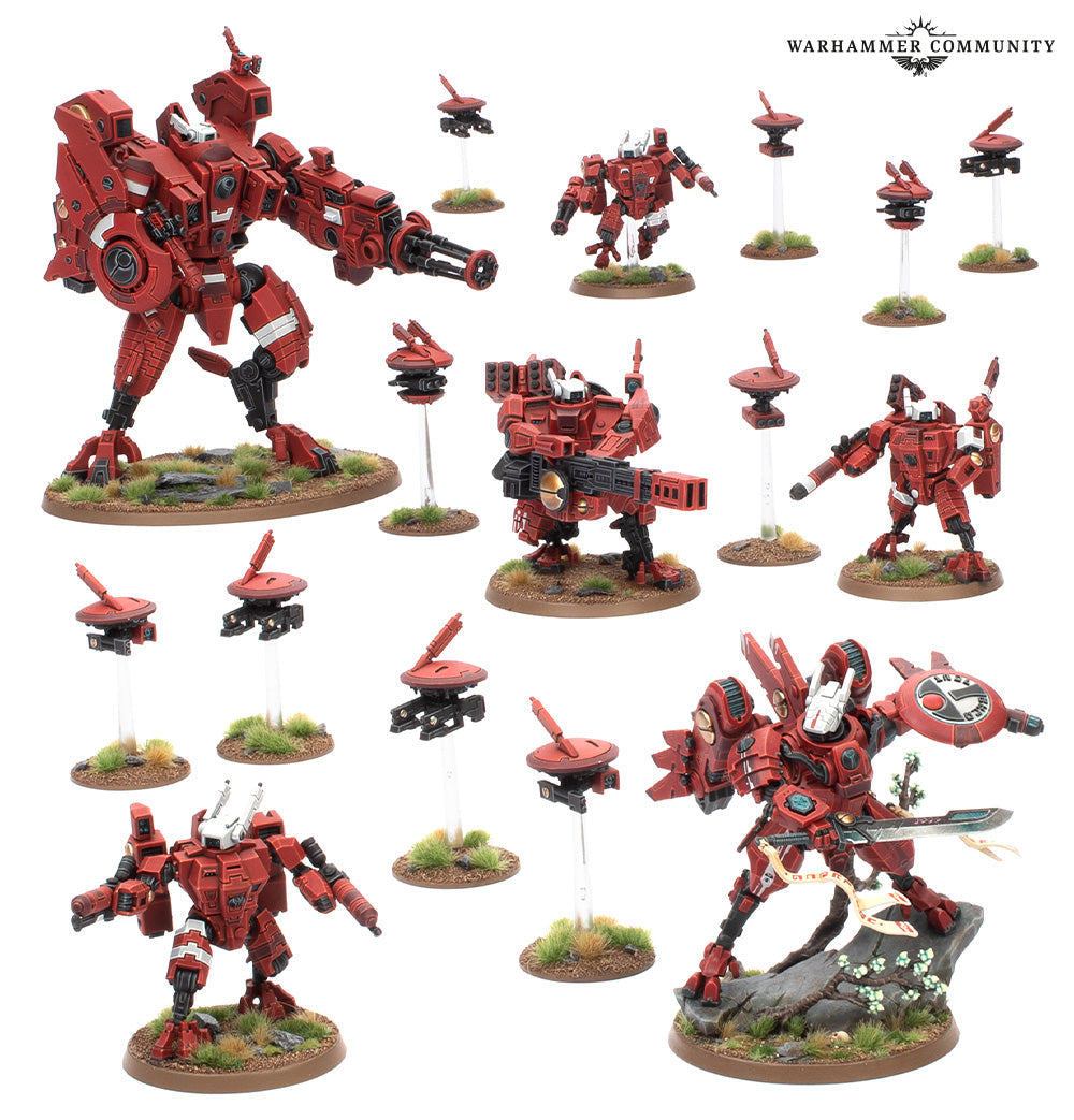 An array of assembled and painted T'au Empire Farsight Enclaves miniatures showing five red battlesuits including Commander Farsight and eight drones on scenic bases