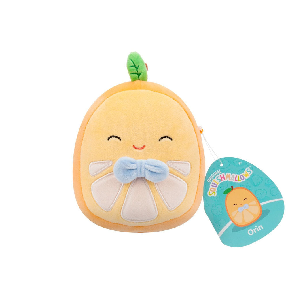 An orange slice Squishmallow plush toy, named Orin, smiling with a blue bowtie and a green leaf
