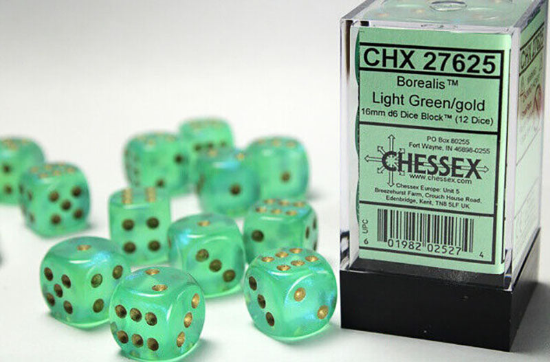 Chessex Borealis light green/gold 16mm d6 dice scattered around their clear plastic block container with a green label