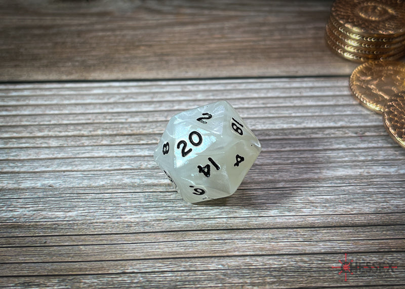 Iridescent white d20 dice showing '20' on top, on a wooden surface, with gold coins nearby