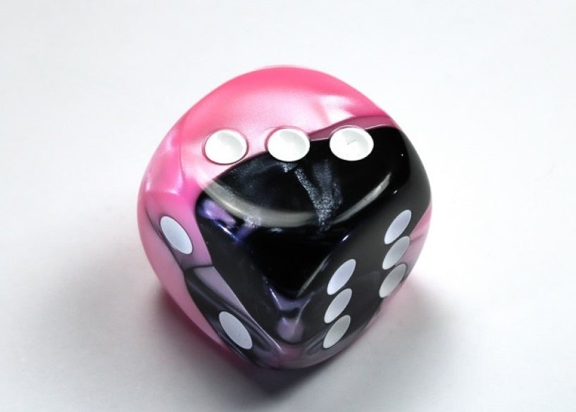 Black and Pink and White die showing 2, 3 and 6 faces with white pips visible, on a white background