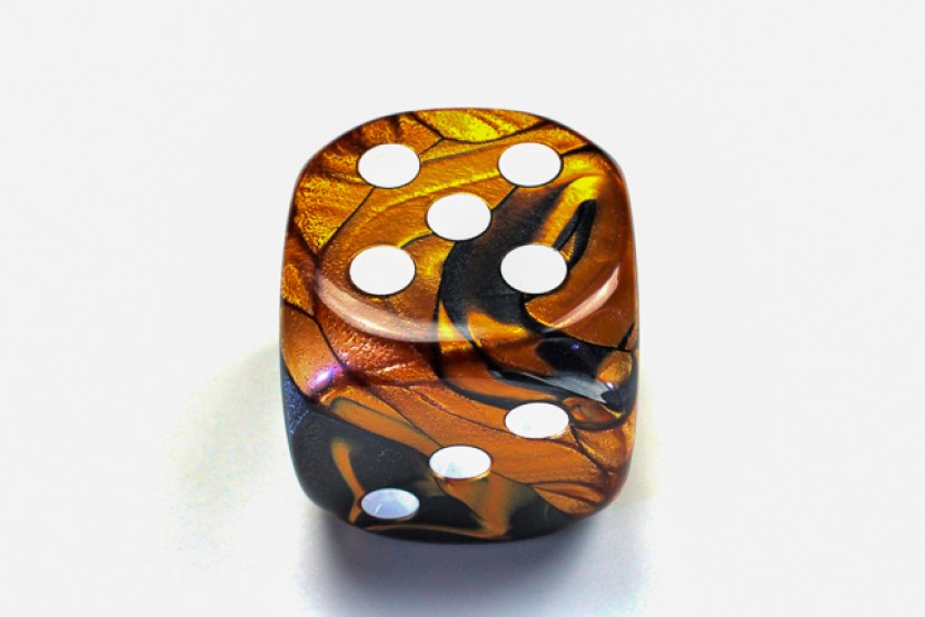 Black Copper and White die showing 5 and 3 faces with white pips visible, on a white background