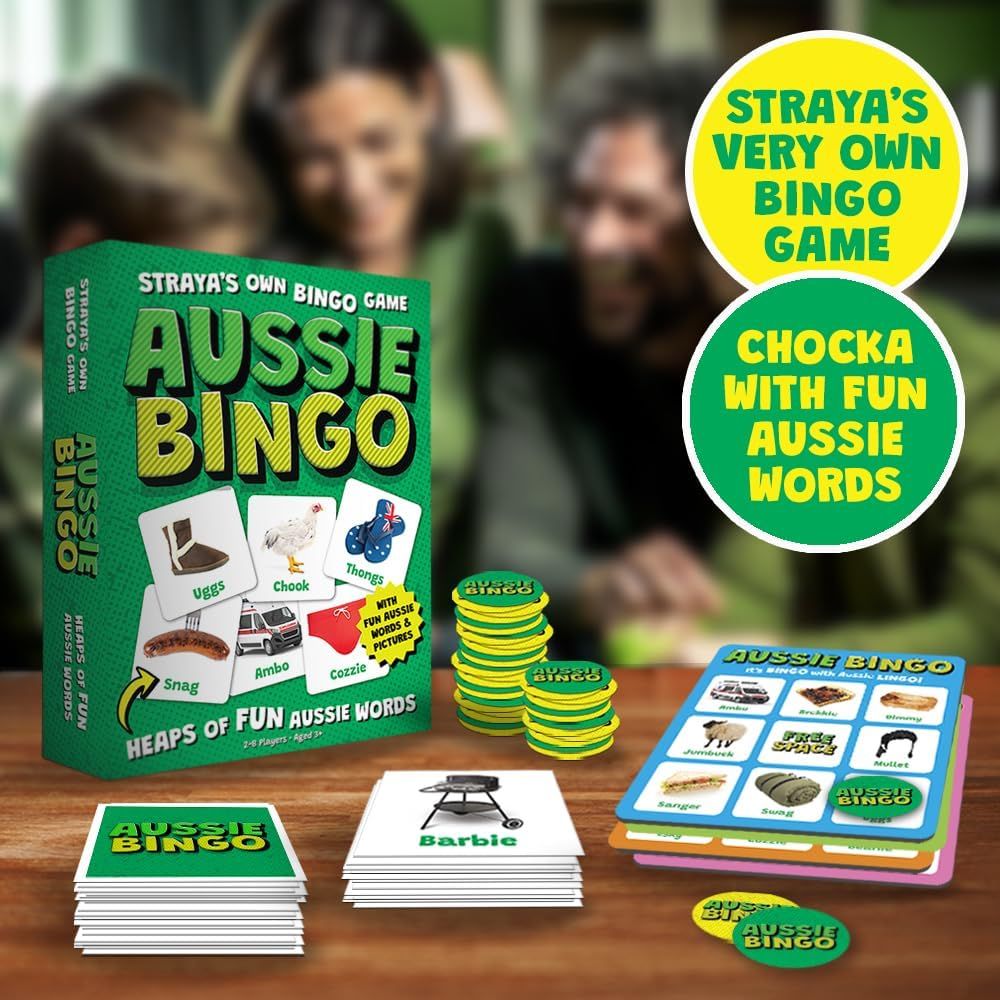 Close-up of the Aussie Bingo game box and cards (Ugg's, Chook, Thongs) with tokens on a wooden surface, people blurred in background