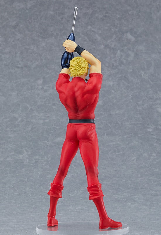 Back view of a blonde male action figure in a red jumpsuit and blue gloves holding a silver rifle over his head