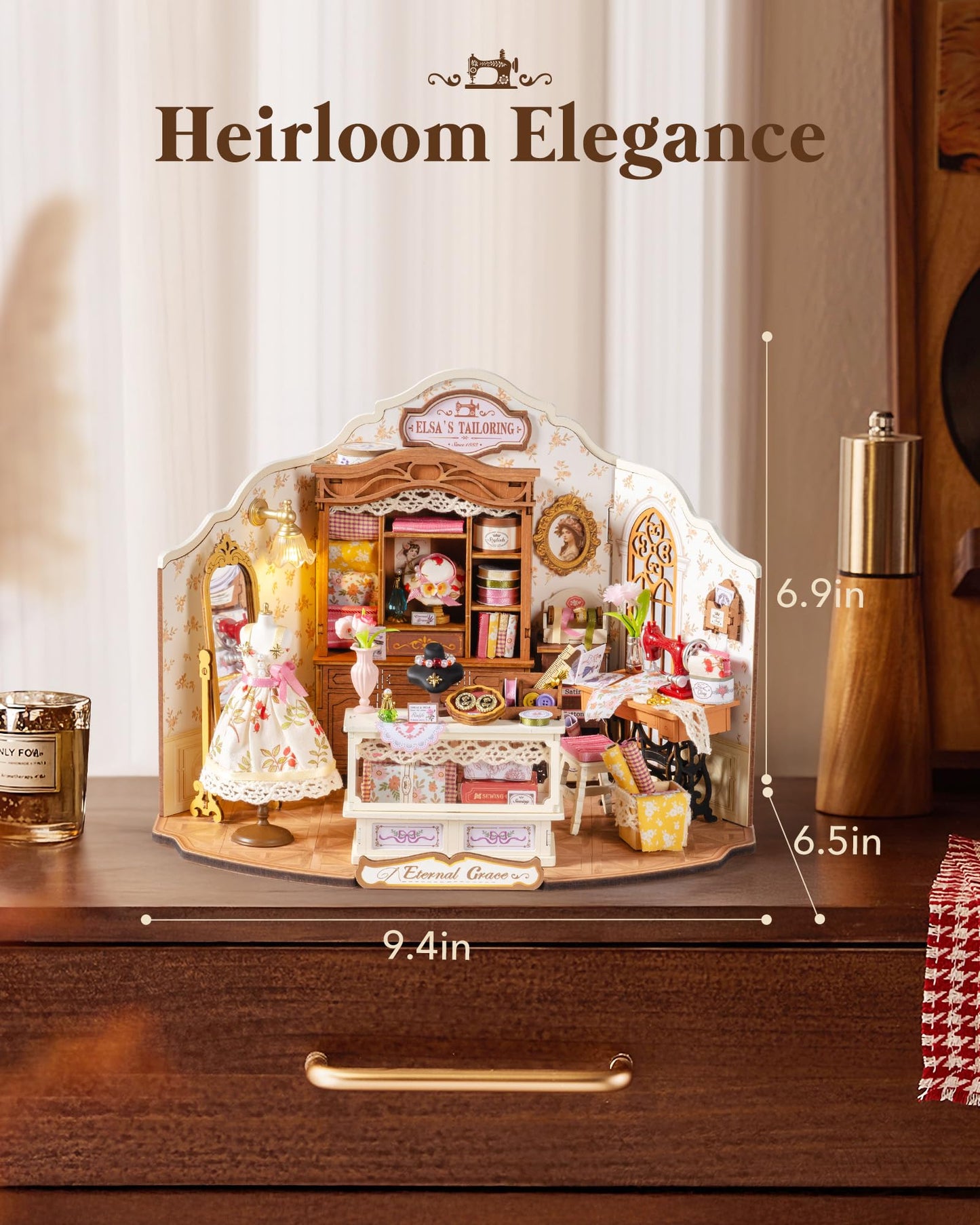 A beautiful assembled miniature Elsa's Tailoring dollhouse featuring a tiny mannequin and sewing machine measures 9