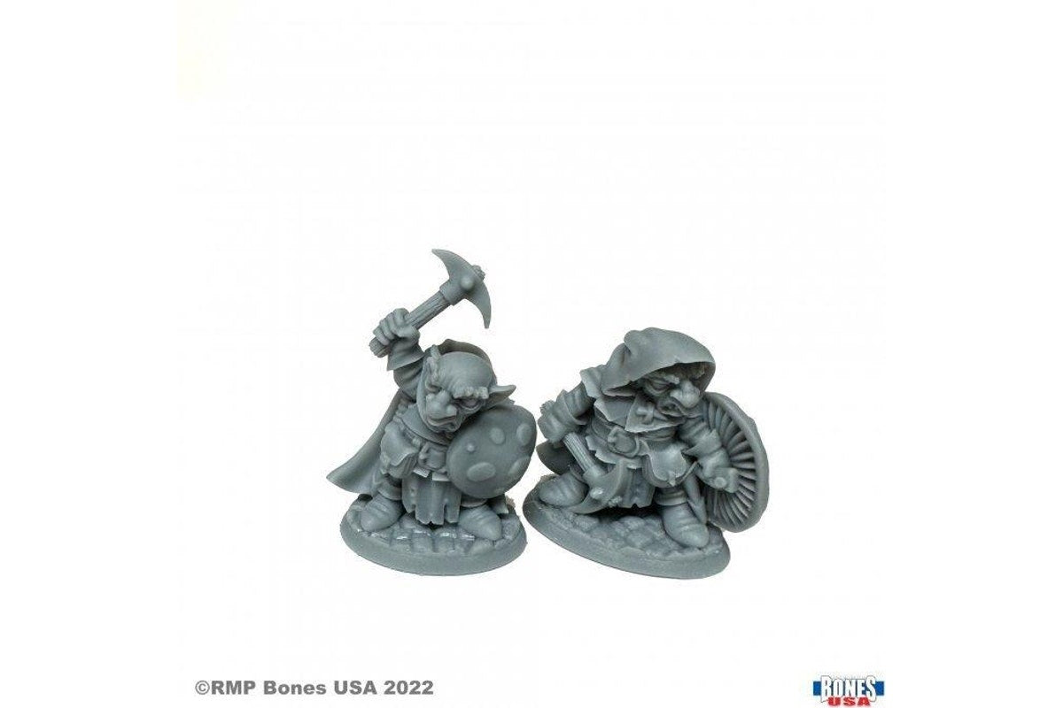 Unpainted grey fantasy miniatures: two goblins/gnomes wielding a pickaxe, axe, and detailed mushroom shields for tabletop RPG gaming