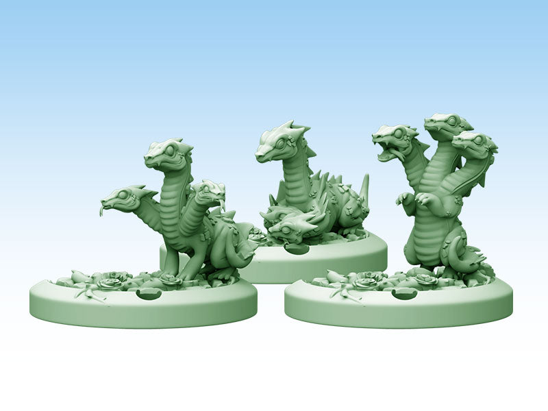 Three unpainted, mint green chibi hydra miniatures on floral bases, showing varying numbers of heads