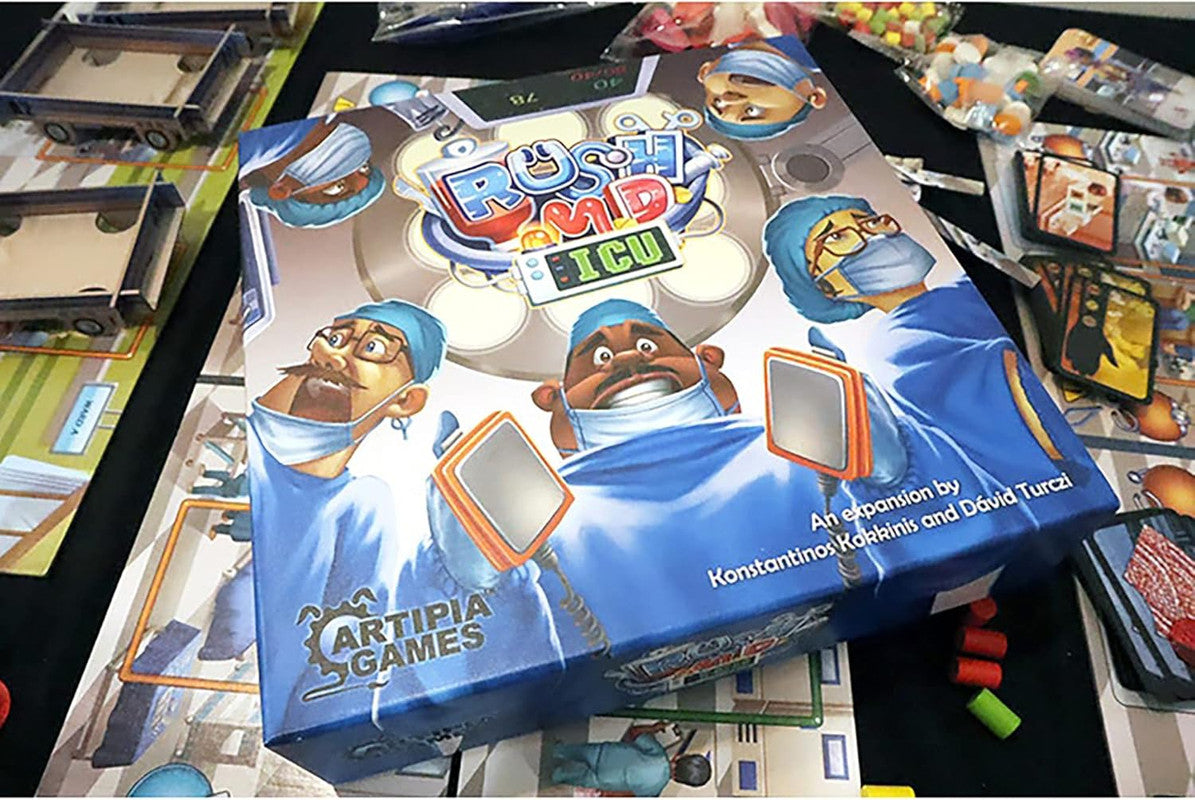 Rush M.D.: ICU Expansion board game box, featuring cartoon doctors with defibrillators, on a table with game components