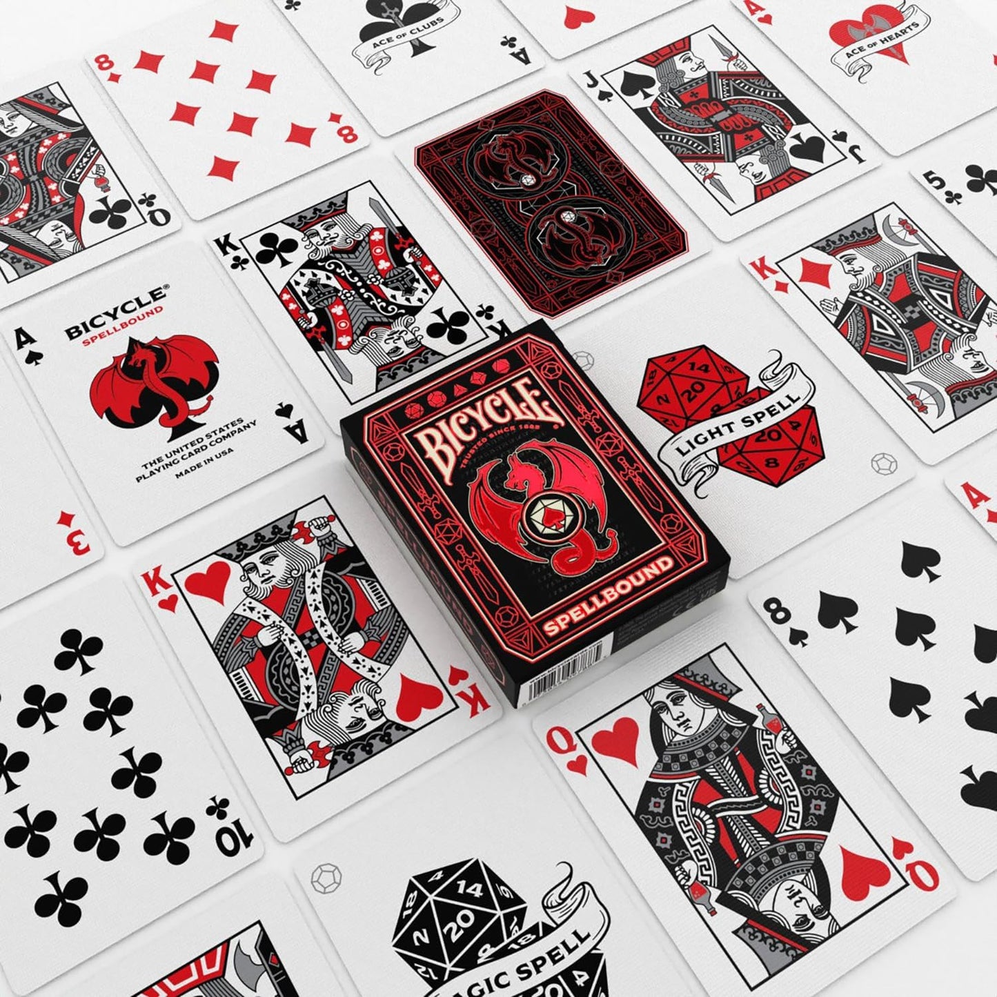 Custom red and black Bicycle Spellbound playing cards spread around the matching dragon tuck box