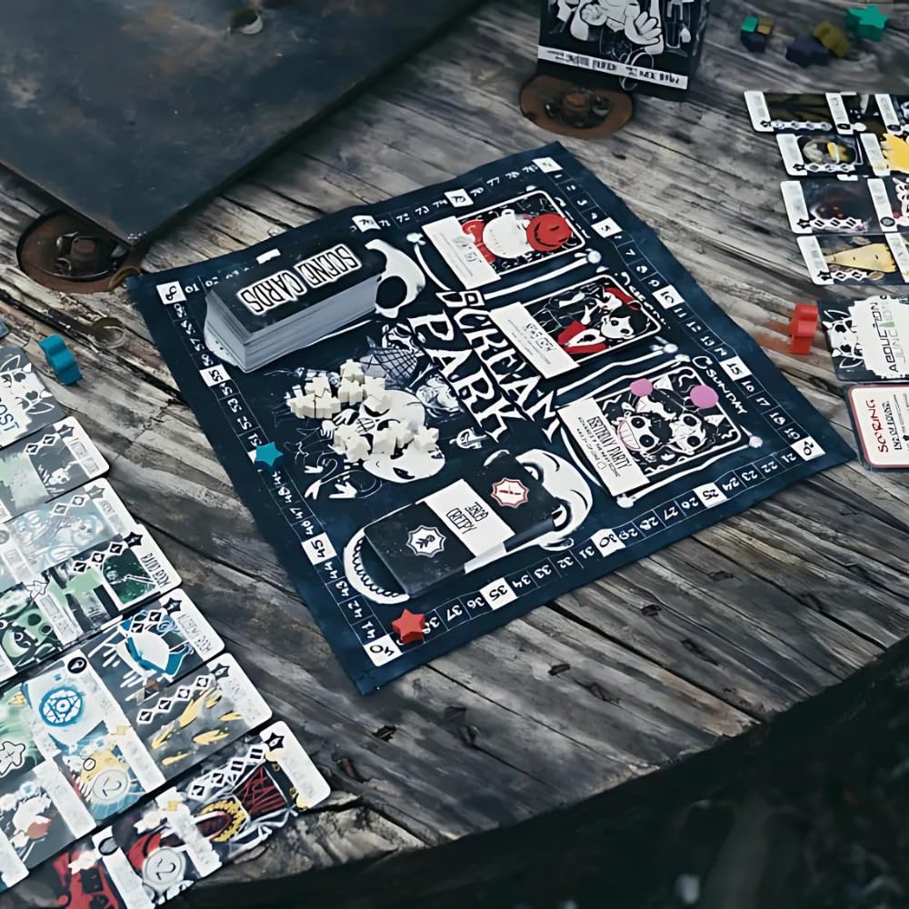 Scream Park board game components including the black cloth playmat, stacked scene cards, and white skull-like tokens are spread across a distressed wooden surface