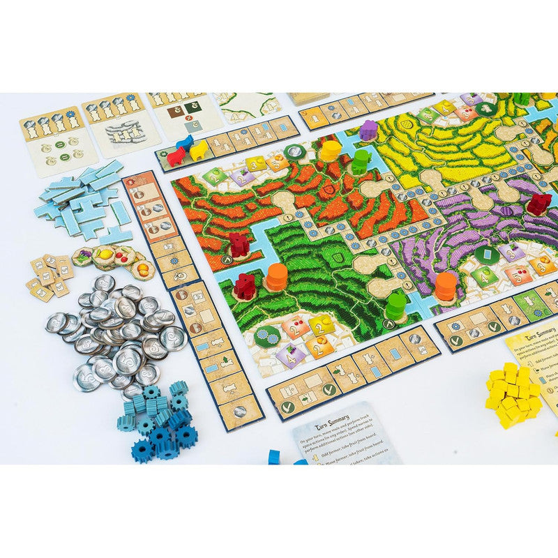Alpujarras board game setup with a vibrant map board featuring various patterned regions, meeples, coins, cards, and game pieces
