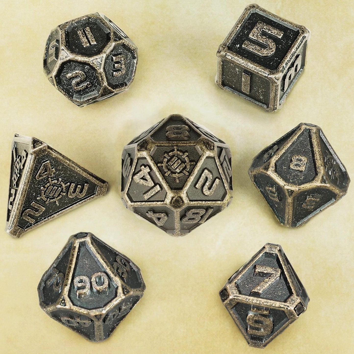 A set of 7 dark metal polyhedral dice for TTRPGs, scattered on a light textured surface