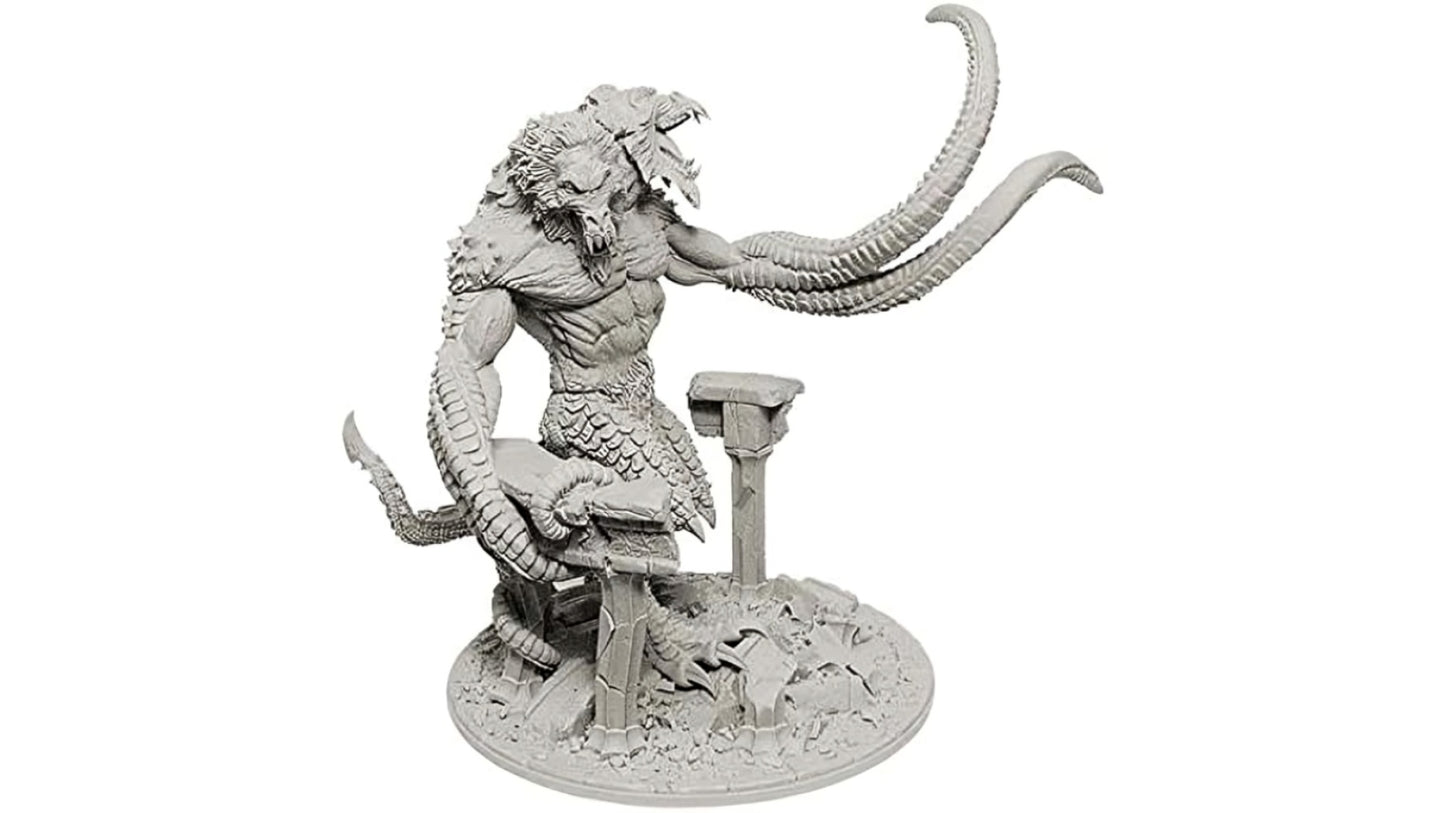 A grey Dungeons & Dragons miniature of the Demon Lord Demogorgon, a multi-headed monster with tentacle arms and scaly legs, standing on a ruined base