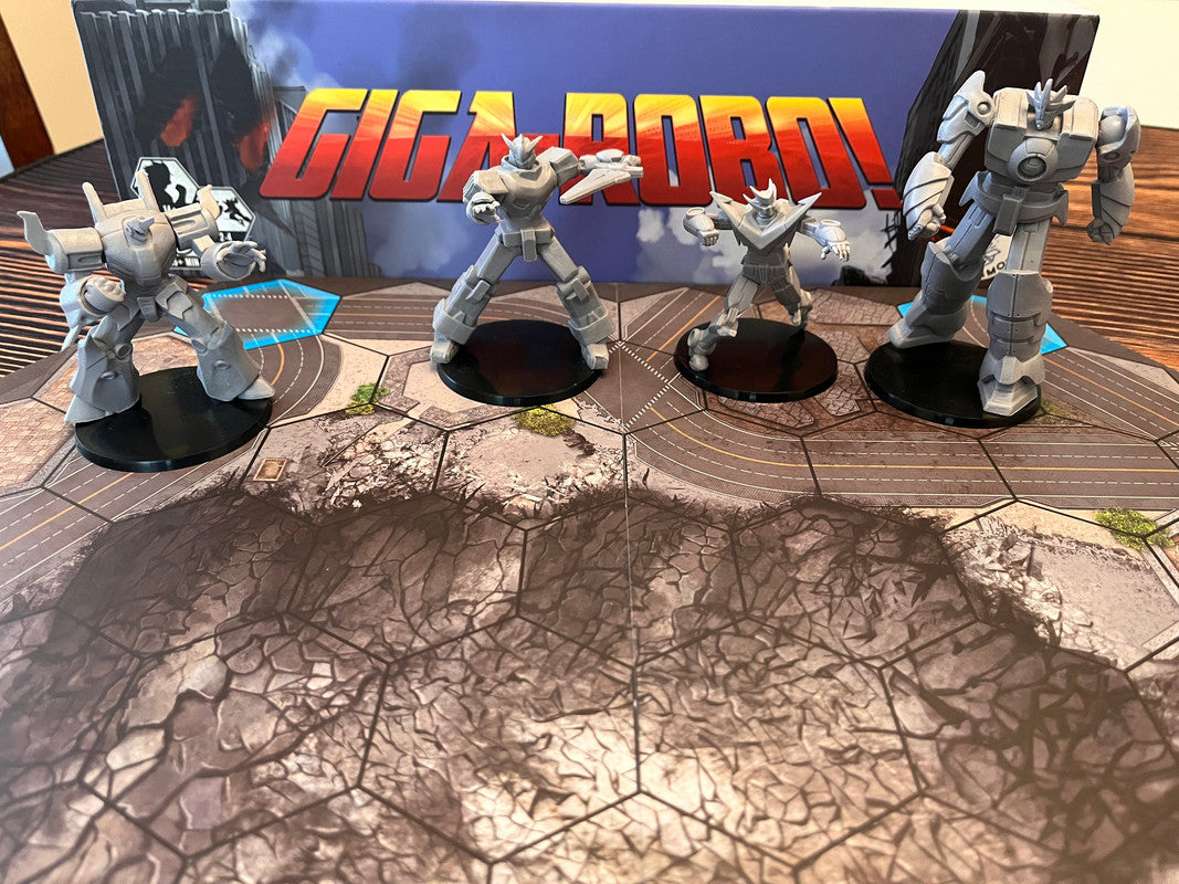 Grey robot miniatures from the GIGA-ROBO! board game stand on a cracked city map