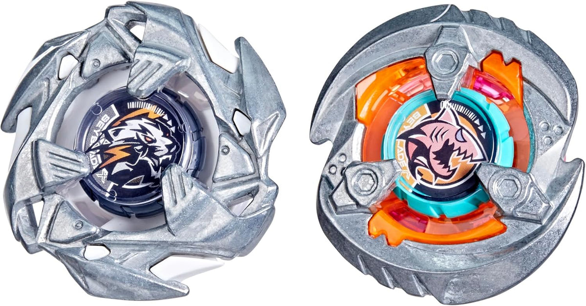 Two Beyblade X tops. Left: dark blue with a white tiger logo. Right: orange and teal with a pink shark logo
