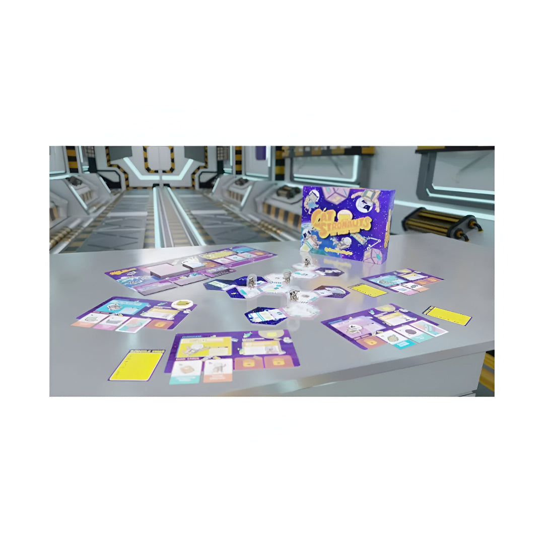 Cat Stronauts board game set up on a grey table in a futuristic spaceship hallway, featuring cards, tiles, and pawns