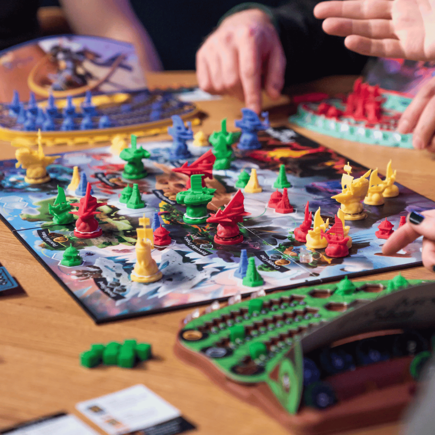 Players' hands moving colourful miniatures on a strategy board game map