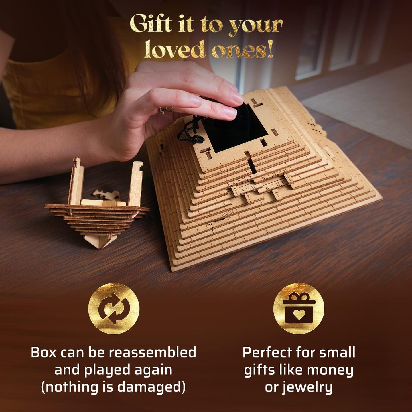 A hand interacts with a wooden pyramid puzzle gift box, revealing a black pouch inside its numbered layers. Another wooden puzzle piece nearby
