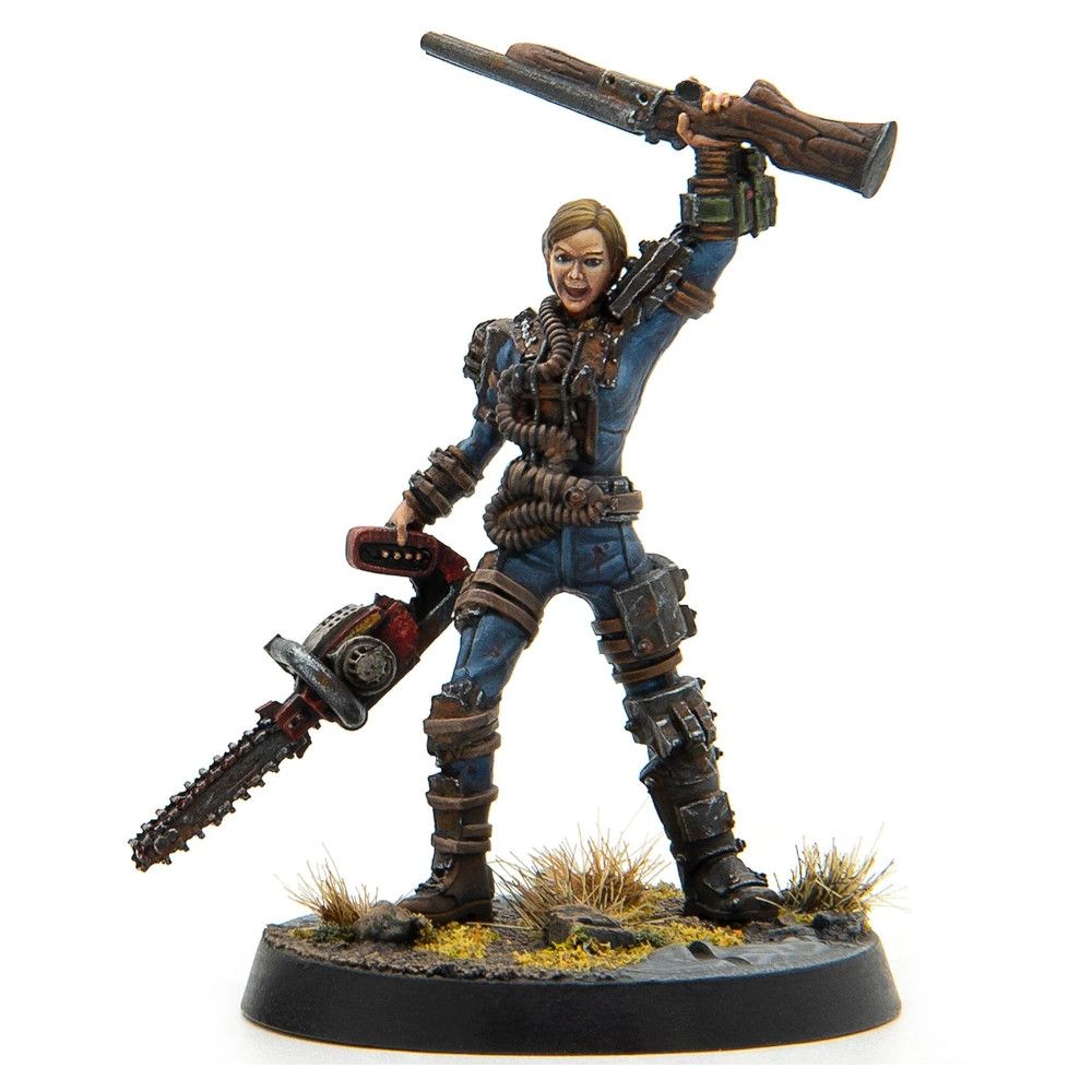 Fierce female miniature in blue jumpsuit with ammo belts, holding a chainsaw and raising a rifle