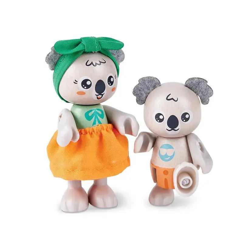 Two smiling wooden koala toys. One in a green bow & orange skirt, the other with felt ears, orange shorts, & one leg bent.