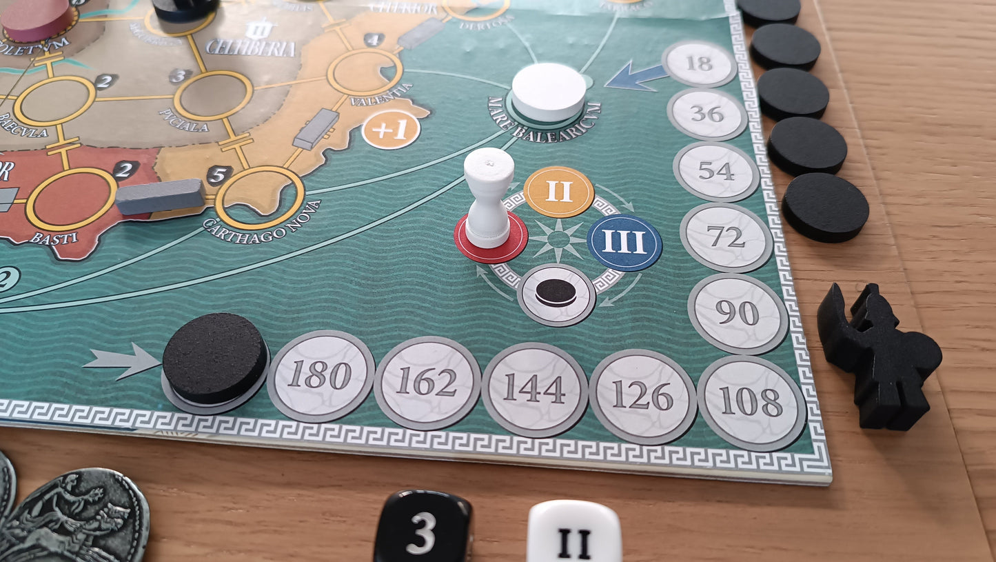 A close-up of a strategy board game in play, featuring a white peg on a track with Roman numerals, a map, tokens, and dice