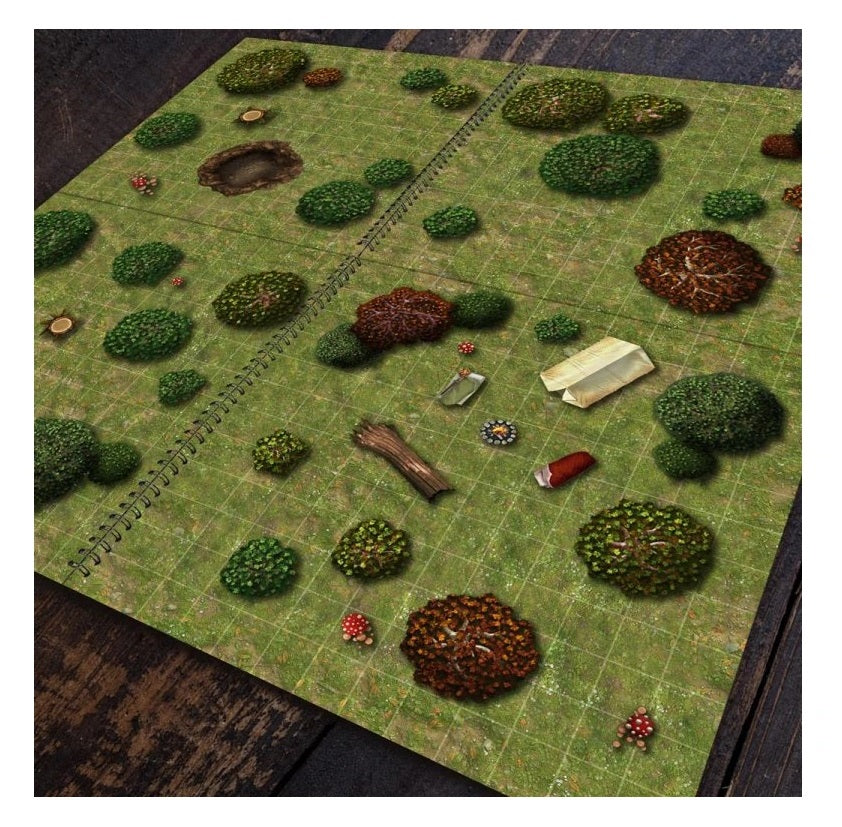 Open spiral-bound RPG map on a grid, showing diverse terrain like trees, bushes, a pond, plus a scroll and campfire.
