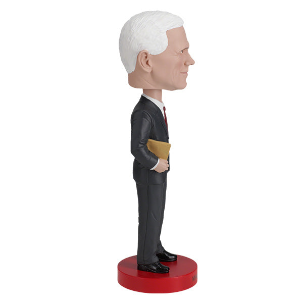 Mike Pence Royal Bobbles bobblehead with a gold binder wearing a gray suit and red tie on a red base