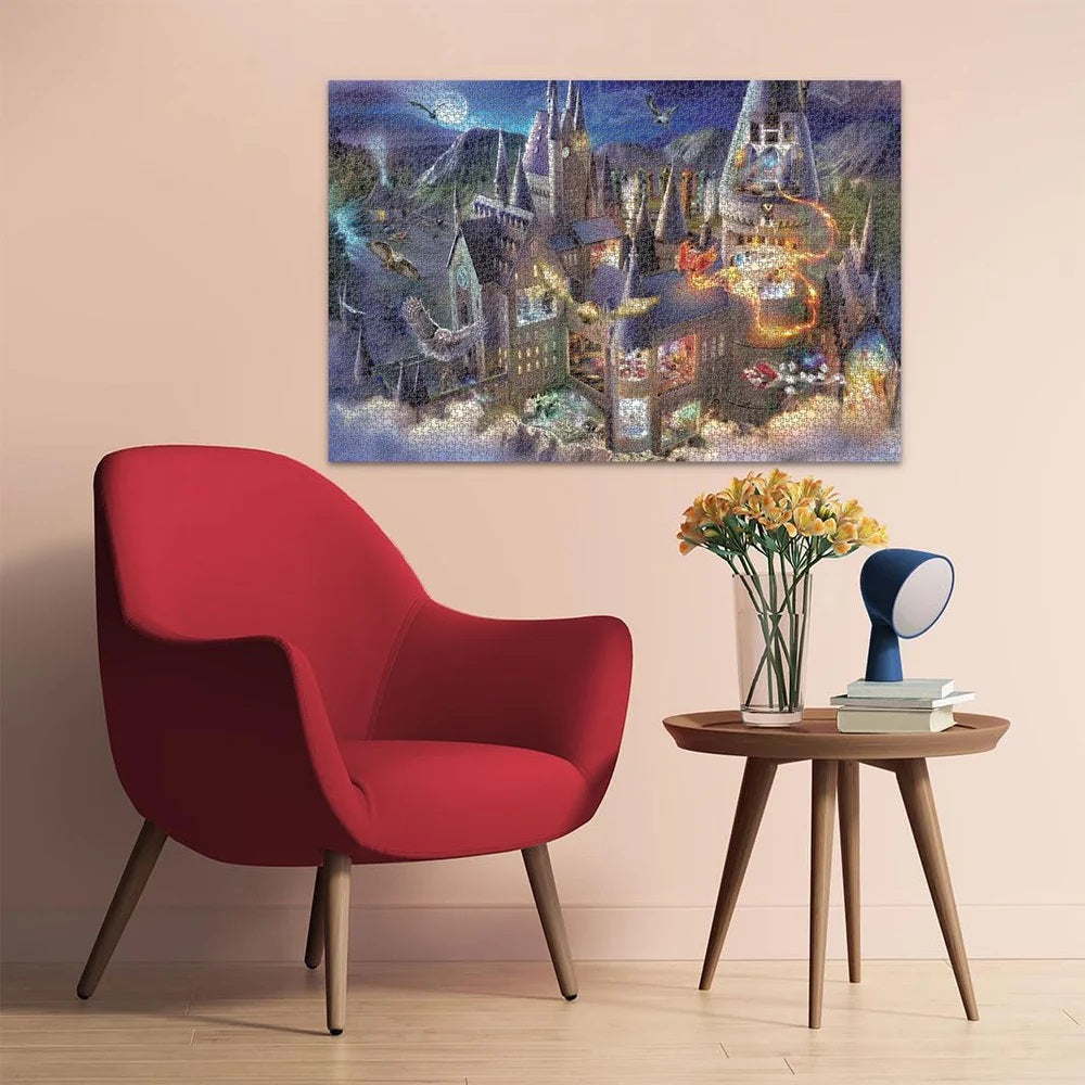 Hogwarts castle puzzle showing a magical night scene with owls flying, above a red armchair and side table with flowers