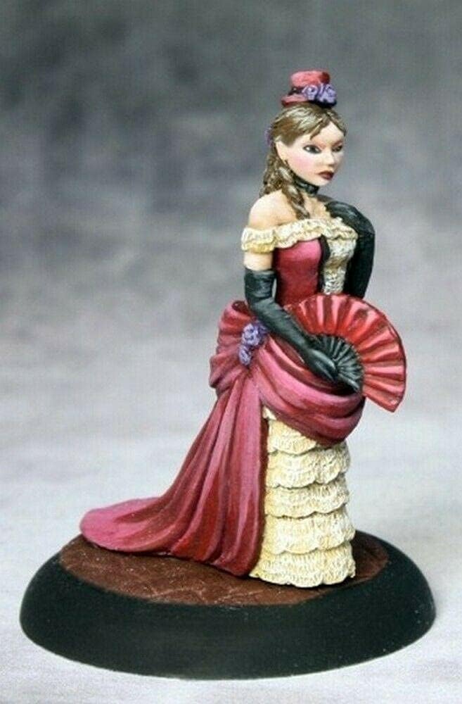 Miniature woman in a red bustle dress with cream ruffles, black gloves, holding a red fan