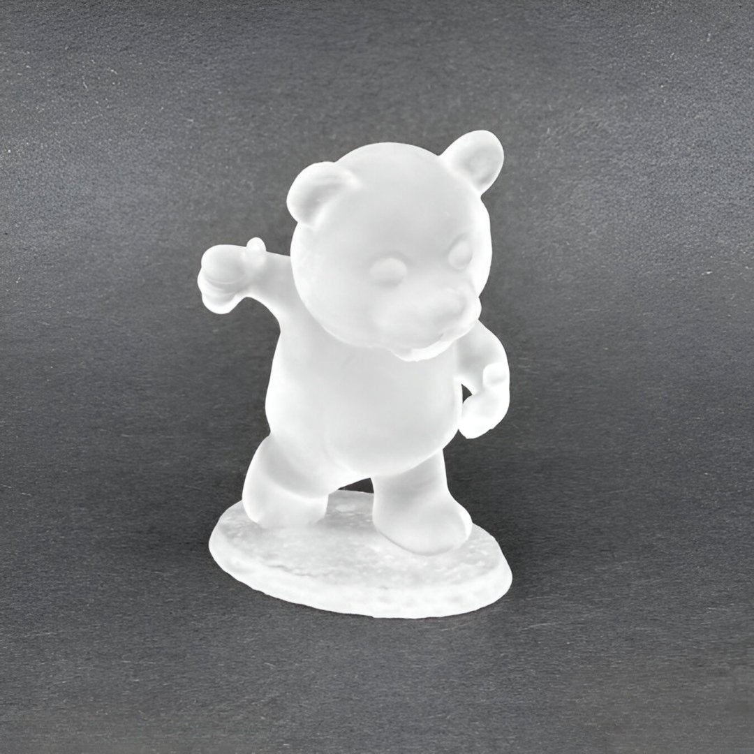 Frosted white bear figurine standing with left arm raised, thumb up, against a dark background