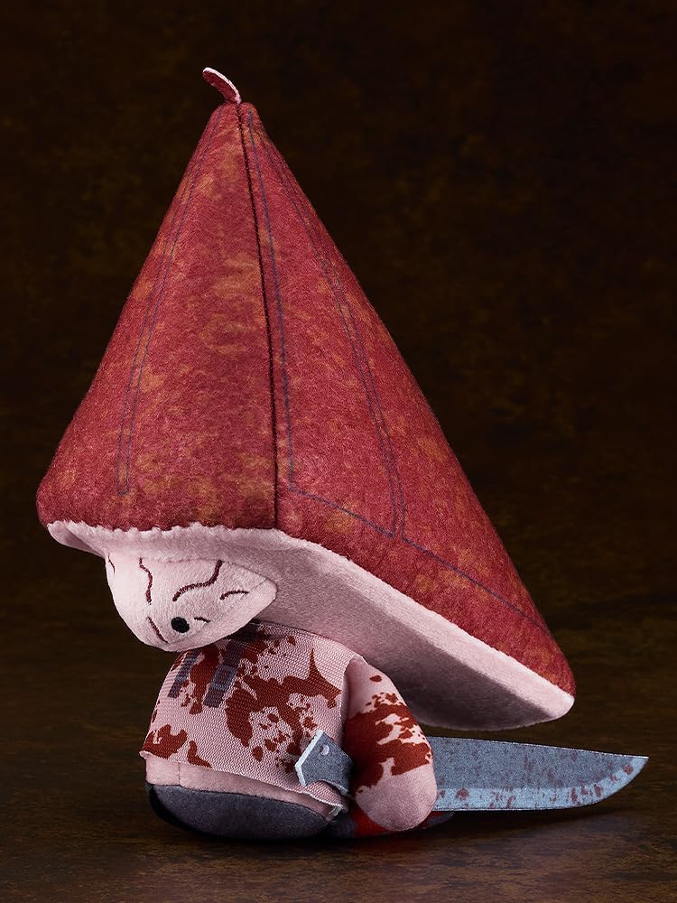 Red Pyramid Thing plush doll with a large reddish-brown conical hat, stitched face, and a spotted body, holding a rusty knife