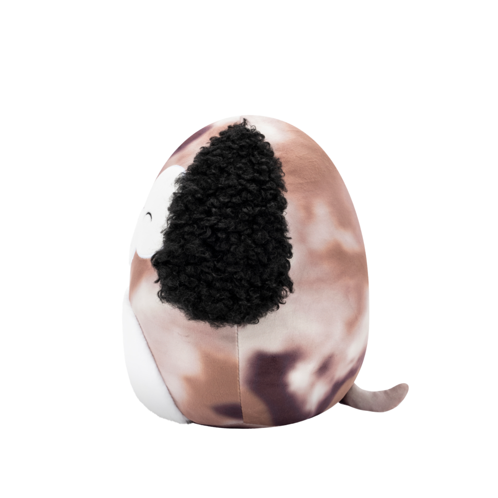 Side view of round plush dog toy with speckled brown body, curly black ears, white belly, and a winking, smiling face