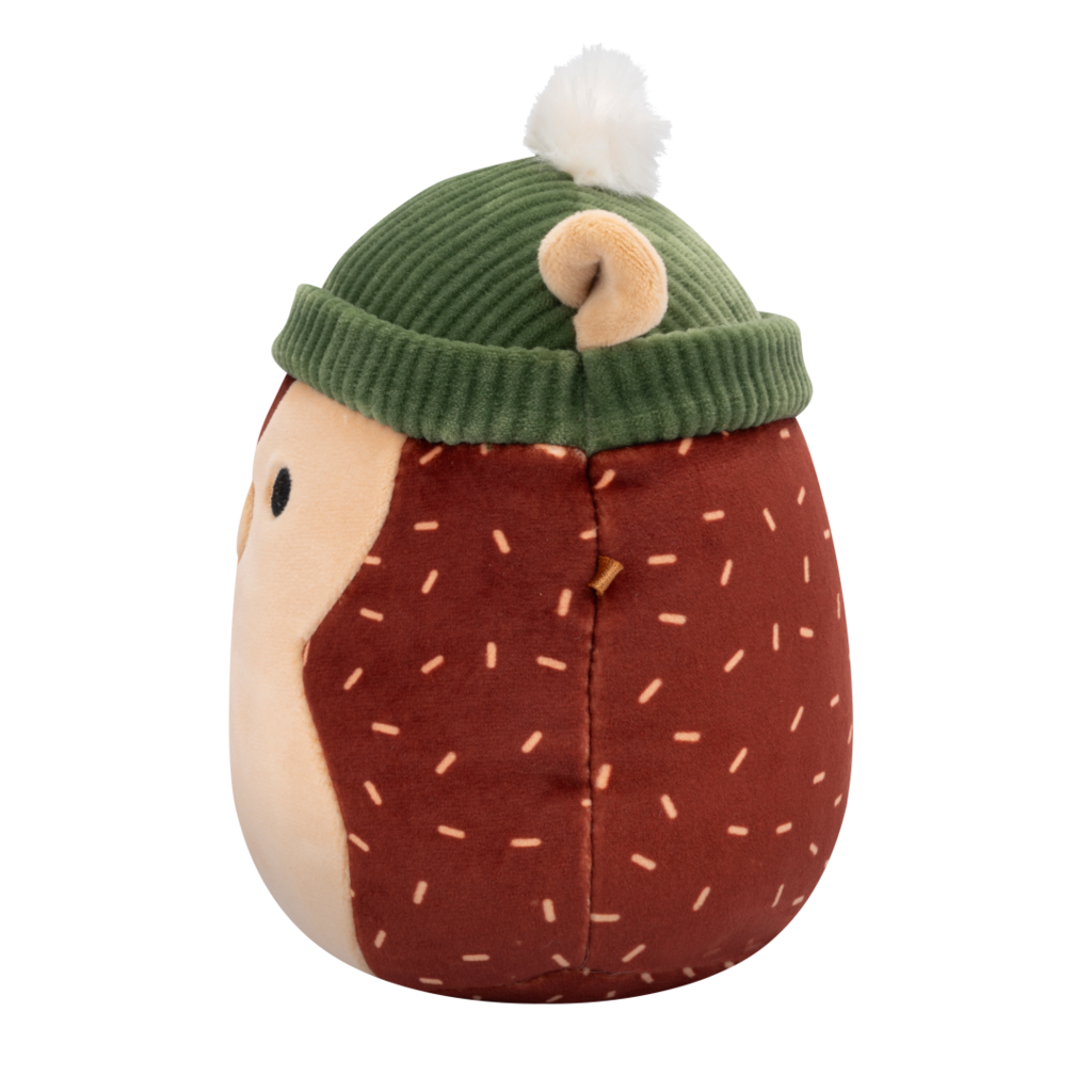 Side view of Squishmallow hedgehog plush toy with a brown body, tan face, and light brown dash patterns, wearing a green ribbed beanie with a white pom-pom