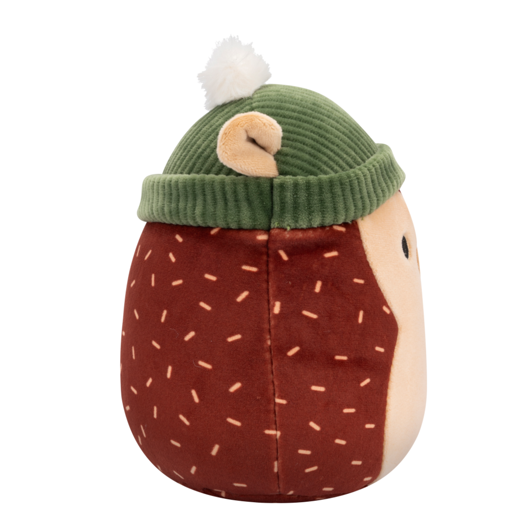 Side view of Squishmallow hedgehog plush toy with a brown body, tan face, and light brown dash patterns, wearing a green ribbed beanie with a white pom-pom