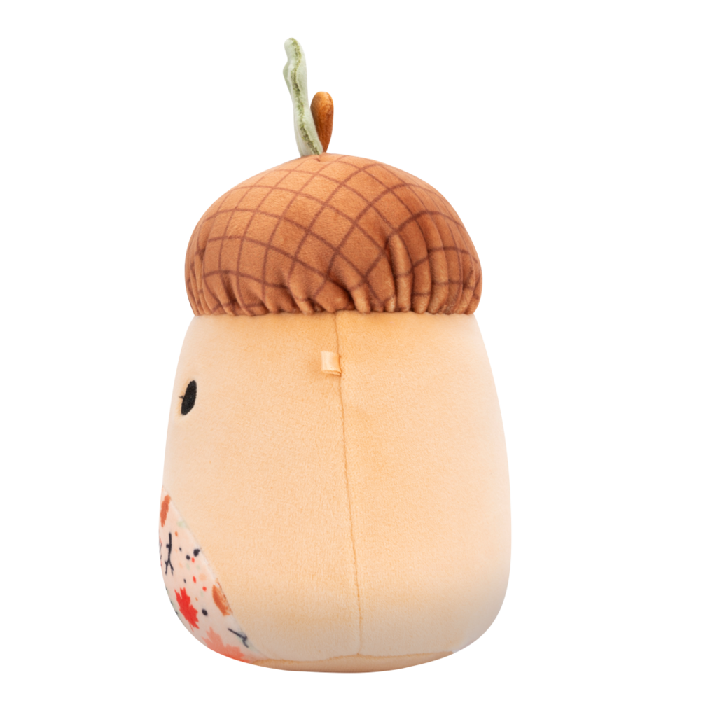 Side view of plush toy with a textured brown cap, green leaf stem, friendly face, and a belly patterned with colorful autumn leaves and mushrooms