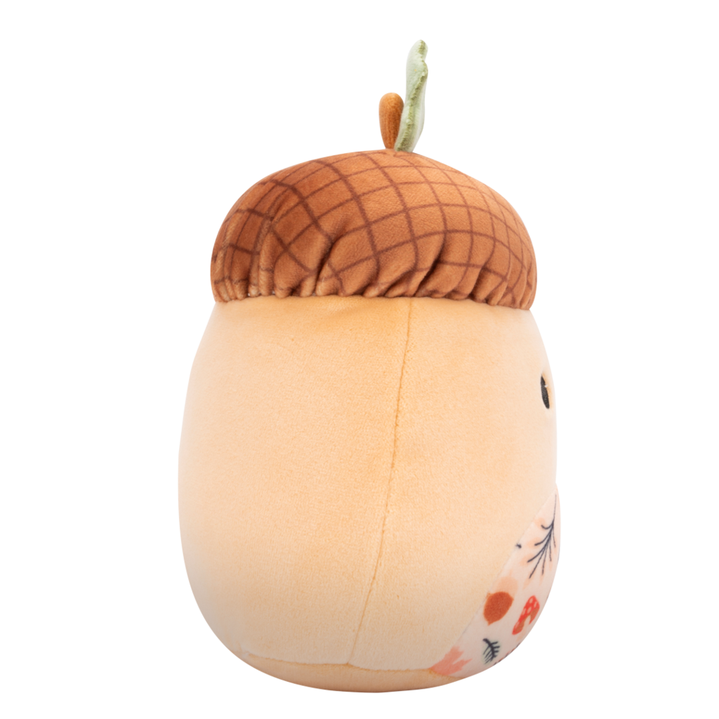 Side view of plush toy with a textured brown cap, green leaf stem, friendly face, and a belly patterned with colorful autumn leaves and mushrooms