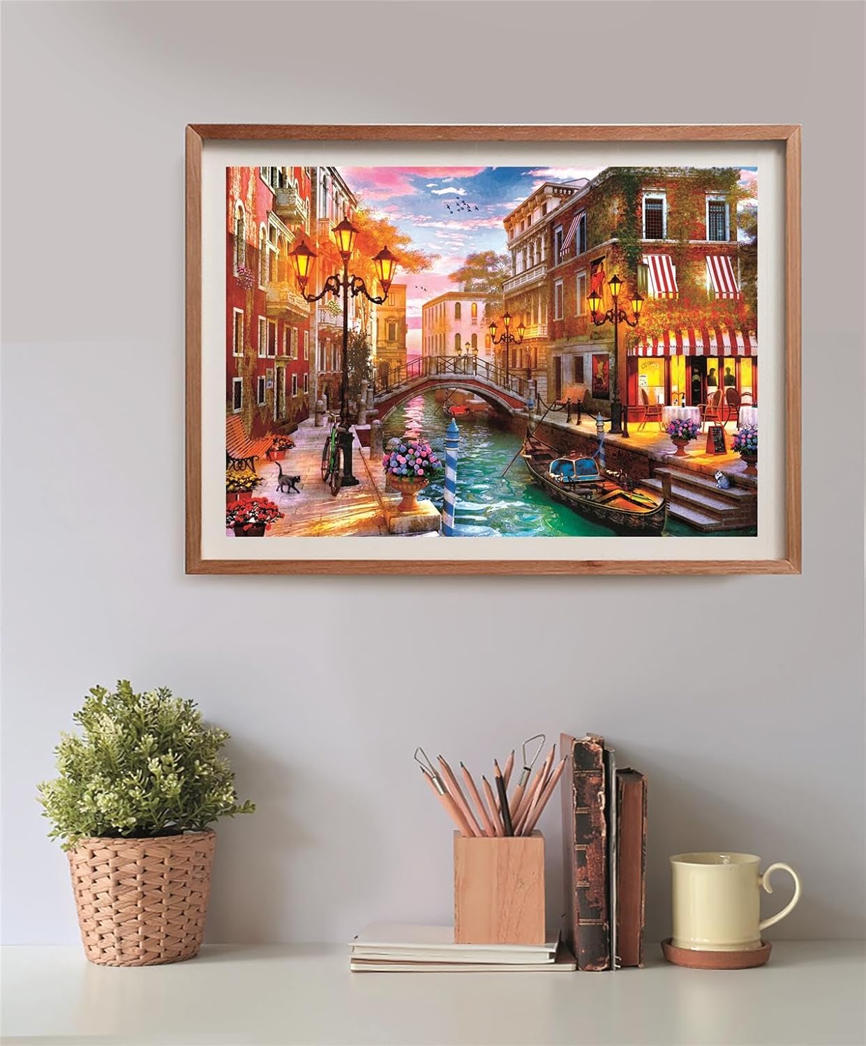 A vibrant framed painting of a Venice canal scene with illuminated street lamps and a gondola