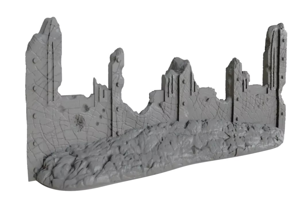 Gray miniature of a ruined building, with damaged walls, exposed rebar, and rubble