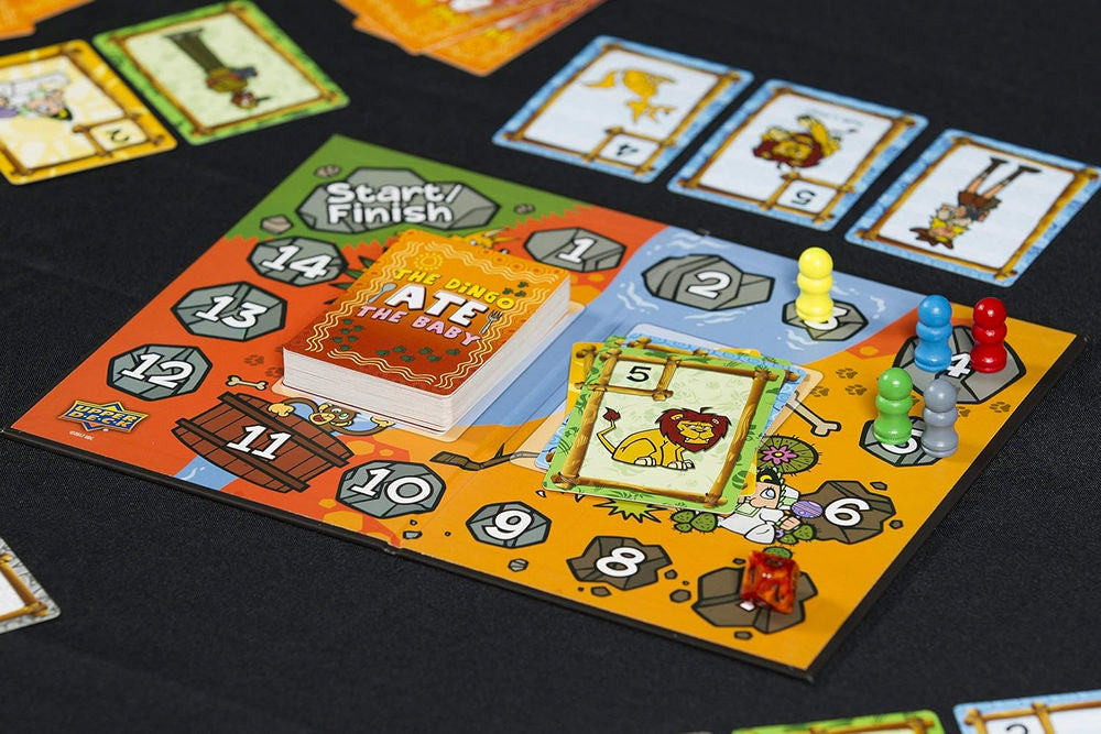 The Dingo Ate The Baby board game: a colorful numbered board, player pawns, and animal-themed cards