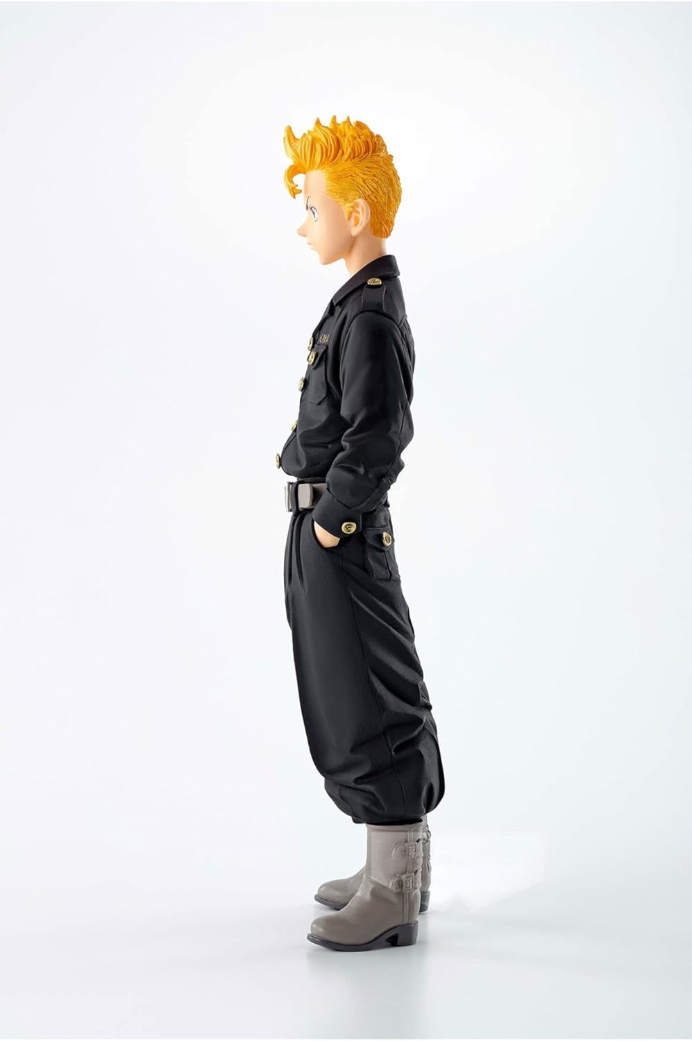 Side view of an anime male figurine with spiky orange hair, wearing a black uniform with gold buttons and grey boots