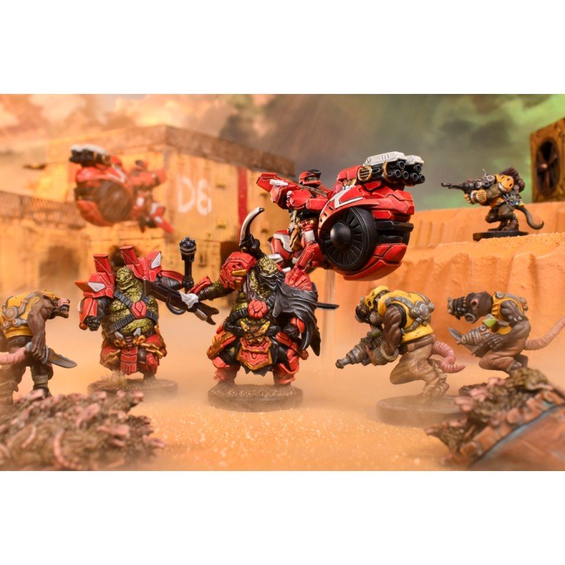 Detailed tabletop miniatures: green-skinned warriors, rat-like figures, and red hoverbikes in a sandy desert skirmish