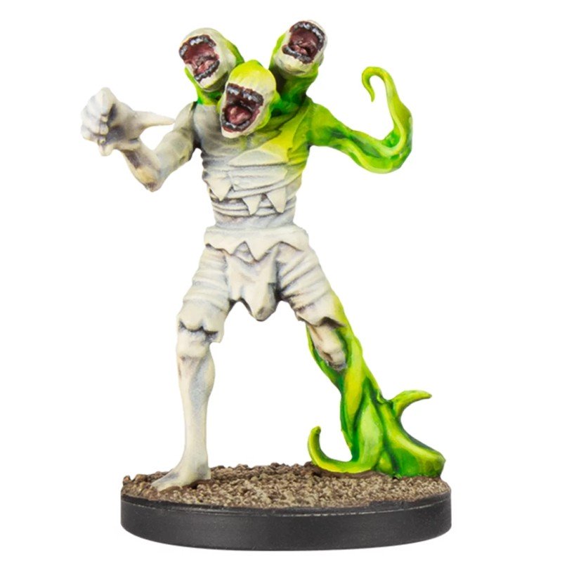 Horrific miniature: a bandaged creature with three open-mouthed heads and green, vine-like limbs, lunging forward