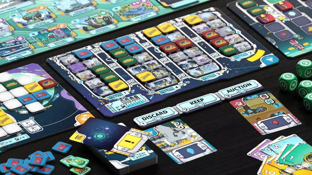 Colorful sci-fi board game components, including tiles, boards, action cards, and green dice, laid out for play