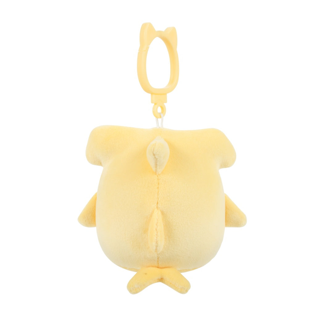 A yellow plush shark keychain, shown from the back, with prominent fins and a cat-eared clip