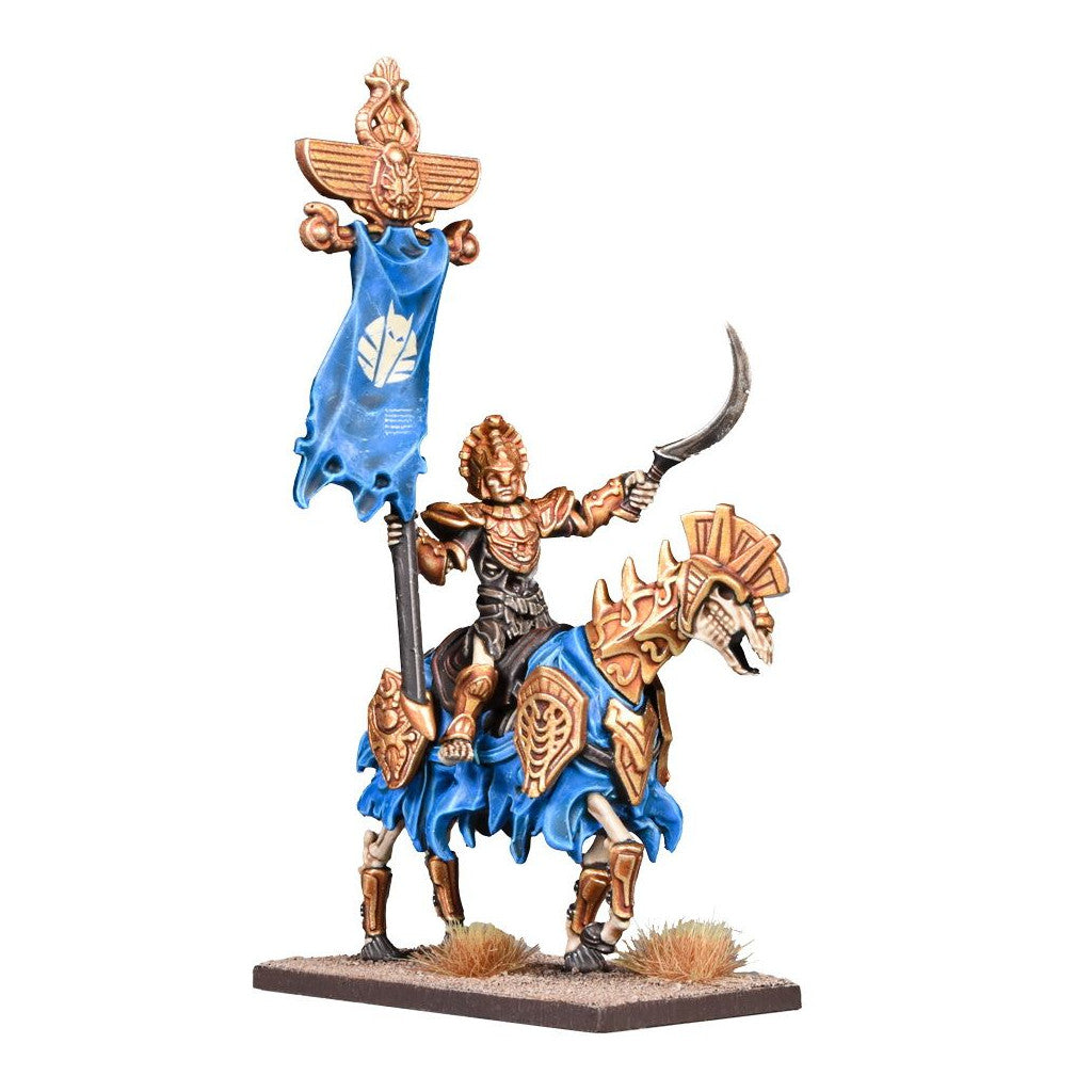 A gold-armored skeletal warrior miniature on a skeletal horse with blue barding, holding a sword and banner